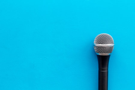 Podcast record with microphone on blue office desk background top view space for textの写真素材
