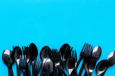 Plastic flatware for eco concept on blue background top view mockupの写真素材