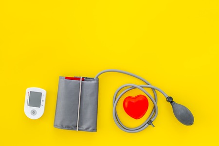 Tonometer for heart diseases diagnostic on yellow desk background top view mockupの写真素材