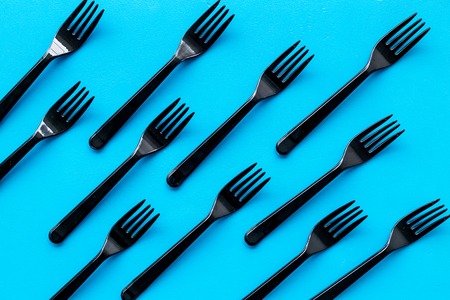Eco and plastic utilization concept with flatware on blue background top view patternの写真素材