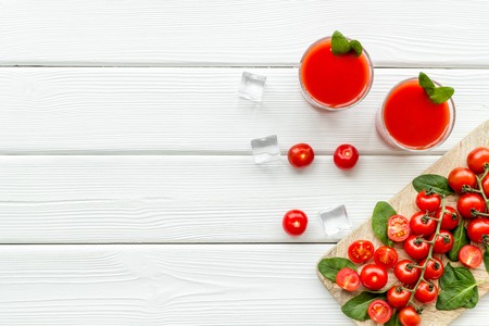 Summer cocktails for freshness with red tomato and ice on white table background top view copyspaceの写真素材