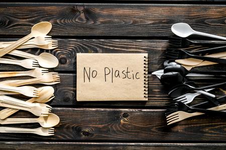 No plastic copy. Planet protection. Eco concept and injunction on the use of plastic flatware on wooden background top view.の写真素材