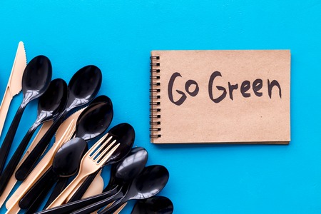 Go green. Eco concept and injunction on the use of plastic flatware on blue background top viewの写真素材