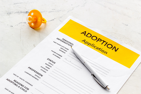 Children care with adoption application and dummy on white office table backgroundの写真素材