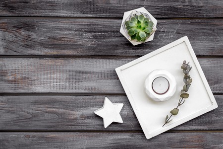 Work desk design with concrete decorations, candle and plant on wooden background top view space for textの写真素材