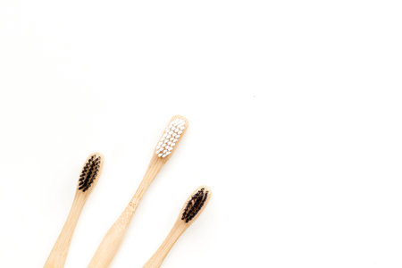 Bamboo dental cleaning brush for zero waste lifestyle concept on white background top view mock up.