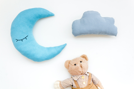 Baby care concept. Baby sleep pattern with moon pillow, cloud, teddy bear on white background top viewの写真素材