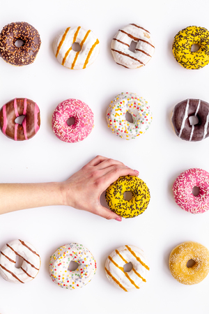 Modern design. Glazed decorated donuts pattern on white background flat layの写真素材