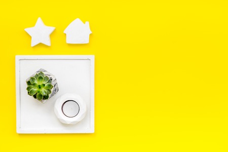 Concrete figures and tray decorations for modern home office design on yellow work desk background flat lay mockupの写真素材