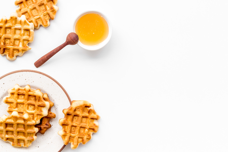 Hot homemade breakfast. Traditional Belgian waffles with honey on served wooden table background top view mockupの写真素材