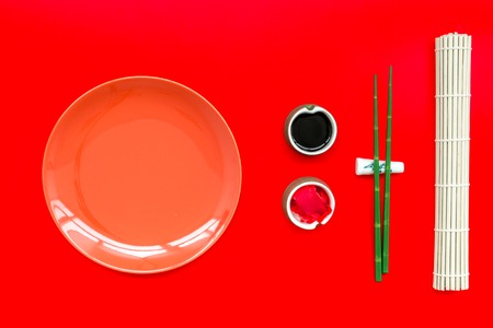 Bamboo sticks, soy sauce, ginger and dishes for sushiの写真素材