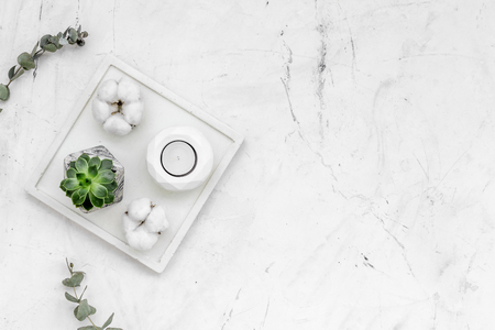 Work desk design with concrete decorations, candle and plant on marble background top view space for textの写真素材