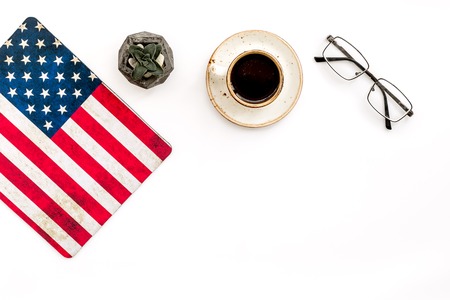 USA national day background with flag, glasses and cup of coffee on white desk top view copy spaceの写真素材