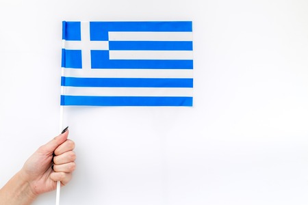 Flag of Greece in hand white background top viewの写真素材
