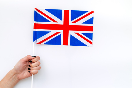 Independence Day of United Kingdom of Great Britain concept with flag in hand on white background top view.の写真素材