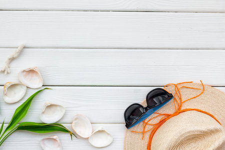 Turistic set. Planning vacation to the seaside with straw hat, sun glasses, shells on white wooden...