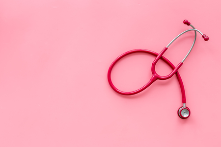 Hospital and diagnostic concept. Stethoscope for family doctor set on pink background top view space for textの写真素材