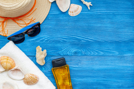 Planning vacation. Summer travelling to the sea with straw hat, sun glasses, shells and sunblock...