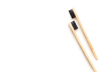 Bamboo dental cleaning brush for zero waste lifestyle concept and care for teeth on white background...