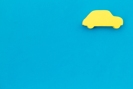 Car buying and insurance concept with car figure on blue desk background top view mock upの写真素材
