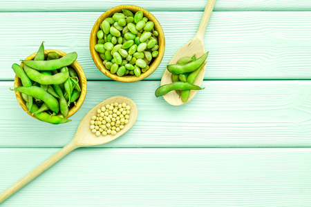Green soybeans or edamame in spoon and bowl for fresh healthy food on mint green background top view space for textの写真素材
