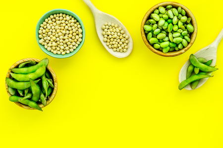Edamame in bowl and spoon on yellow background top view mock upの写真素材
