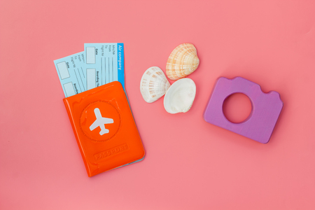 Funny vocation concept with camera, passport and tickets on pink background top viewの写真素材