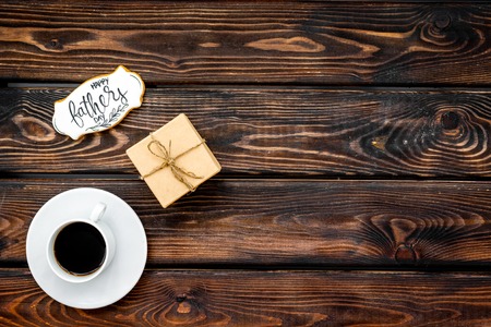 Happy Father Day celebration with gift and cup of coffee on wooden background top view mockupの写真素材