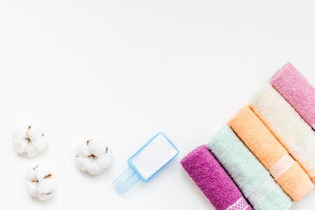 Products of cotton set. Preparing for laundry with washing powder and towels on white background top view copy spaceの写真素材