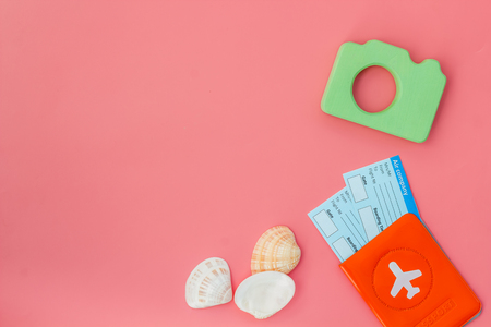 Camera, passport and tickets for summer photo at the seaside on pink background top view mock upの写真素材