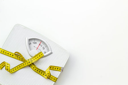 Slim. Medical starvation. Diet concept with scale and measuring tape for weight loss on white...
