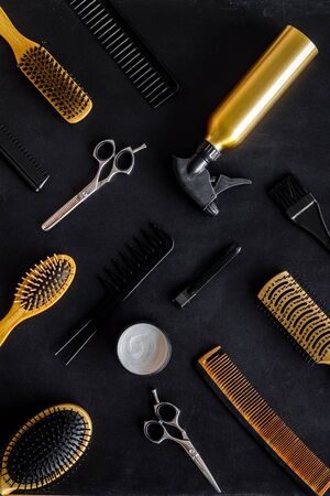 Set of professional hairdresser tools with combs and styling on black background top view patternの写真素材