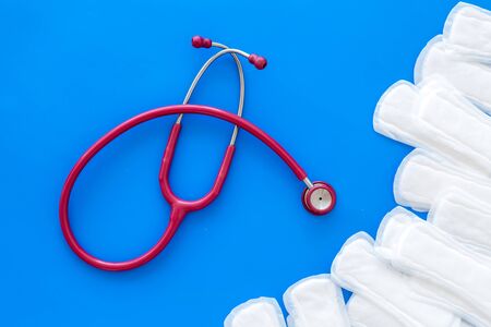 Female health and medicine. Gynaecologist and woman health concept with stethoscope and tampons on blue background top viewの写真素材
