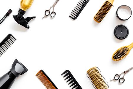 Combs, scissors and hairdresser tools in beauty salon work desk on white background top view space for text