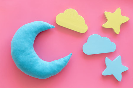 Sleep time concept with moon, stars on pink background top view