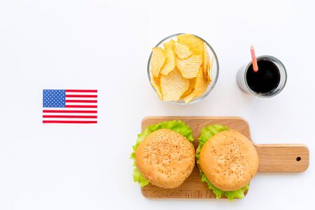 the 4th of July. Independence Day of America concept with flag, burgers, chips on white background top viewの写真素材