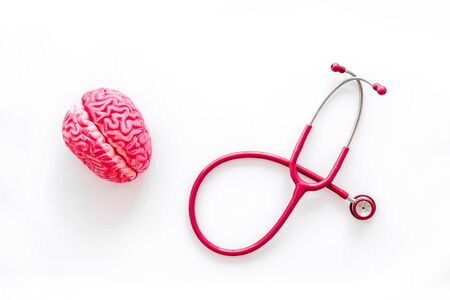Mental diseases. Brain functions concept with brain and stethoscope on white background top viewの写真素材