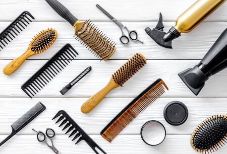 Cut hair. Set of professional hairdresser tools with combs, styling and sciccors on white wooden background top view patternの写真素材