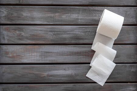 Disease of colon. Proctology concept with toilet paper on wooden background top view mock-upの写真素材