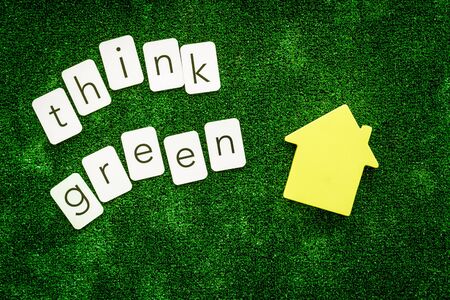 Think green copy and house for ecological concept on green texture background top view.の写真素材