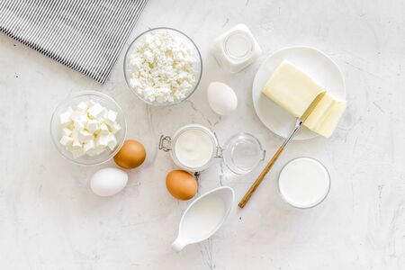 Breakfast on farm with dairy products. Milk, cottage, cheese, yogurt, eggs, butter on marble background top viewの写真素材