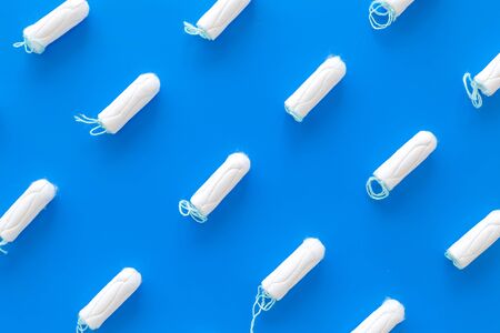 Woman health. Gynaecologist and menstruation concept with tampons pattern on blue background top viewの写真素材