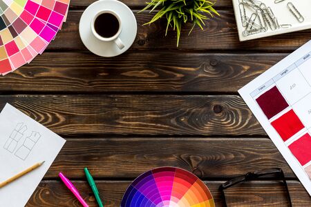 Illustrator, artist tools concept. Work space of designer with instruments, pallet, pencils, glasses and coffee on wooden background top view space for textの写真素材