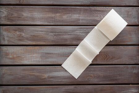 Disease of colon. Toilet paper for proctology diseases concept on wooden background top view mock-upの写真素材