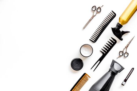 Professional accessories of hairdresser with combs and spray on work desk white background top view copyspaceの写真素材