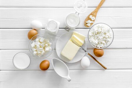 Breakfast on farm with dairy products. Milk, cottage, cheese, yogurt, eggs, butter on white wooden background top viewの写真素材