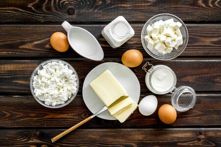 Dairy products from farm with milk, eggs, cottage, butter, yougurt on wooden background top viewの写真素材