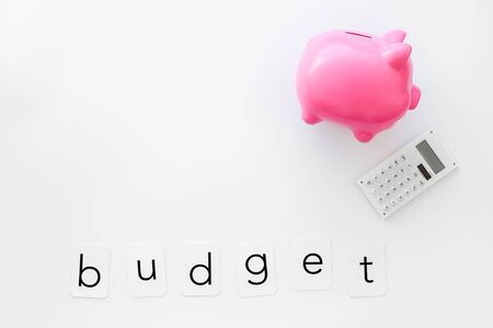 Business and budget concept with piggy bank and calculator on white office work desk background top view mockupの写真素材