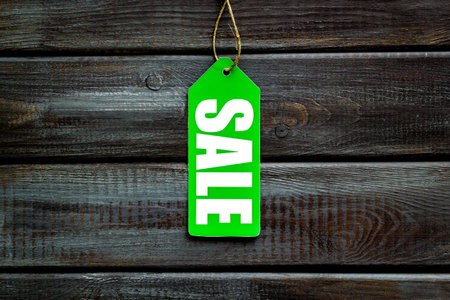 Sale labels on wooden background top viewの写真素材