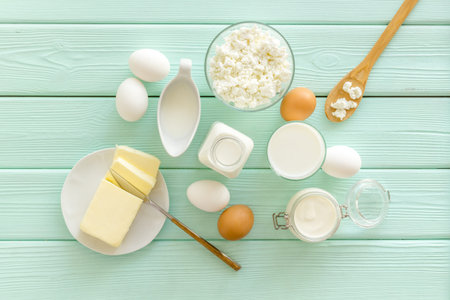 Farm products. Fresh dairy products for breakfast with milk, cottage, eggs, yogurt on mint green...